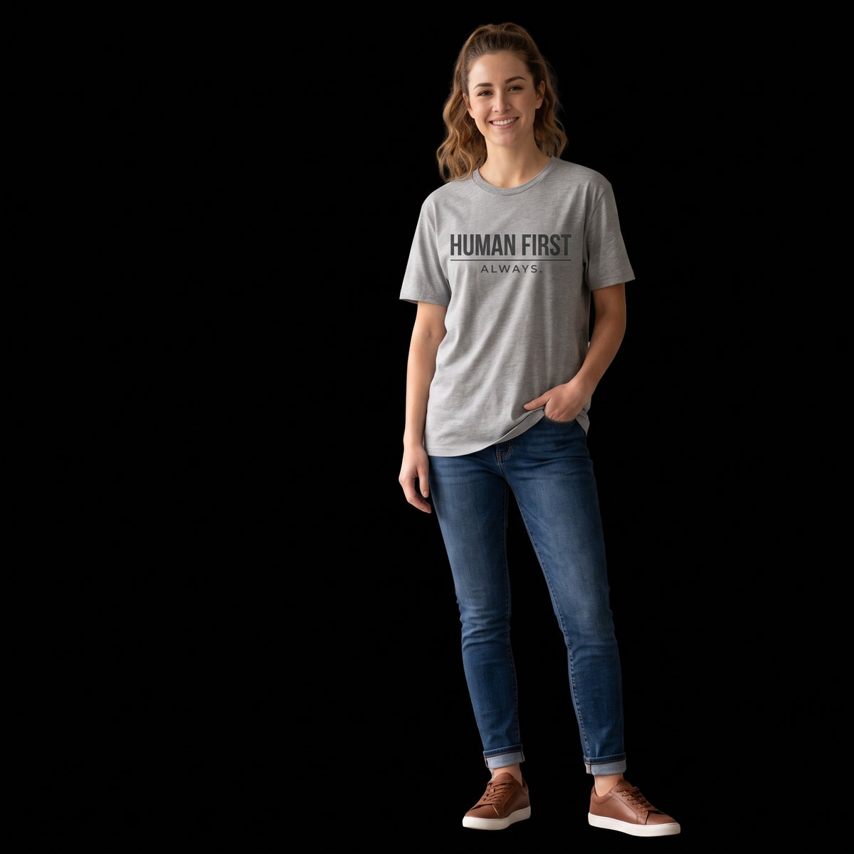 Woman wearing the gray Human First Always T-shirt with jeans, full-length front view